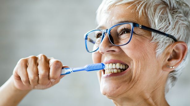 1_Happy-senior-woman-brushing-her-teeth