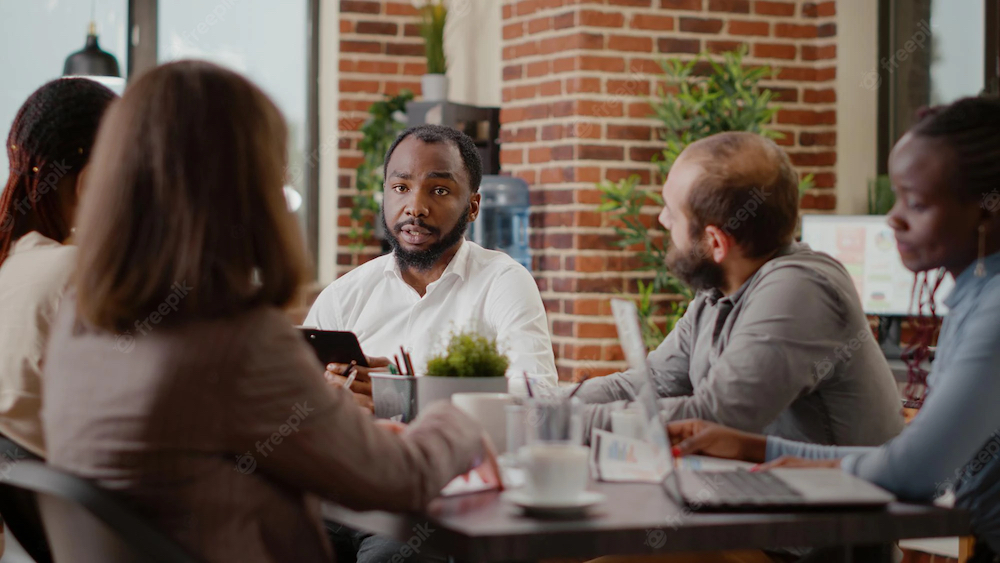 close-up-african-american-man-working-business-project-with-colleagues-planning-marketing-strategy-development-growth-employee-meeting-work-data-analysis-boardroom_482257-37185 copy